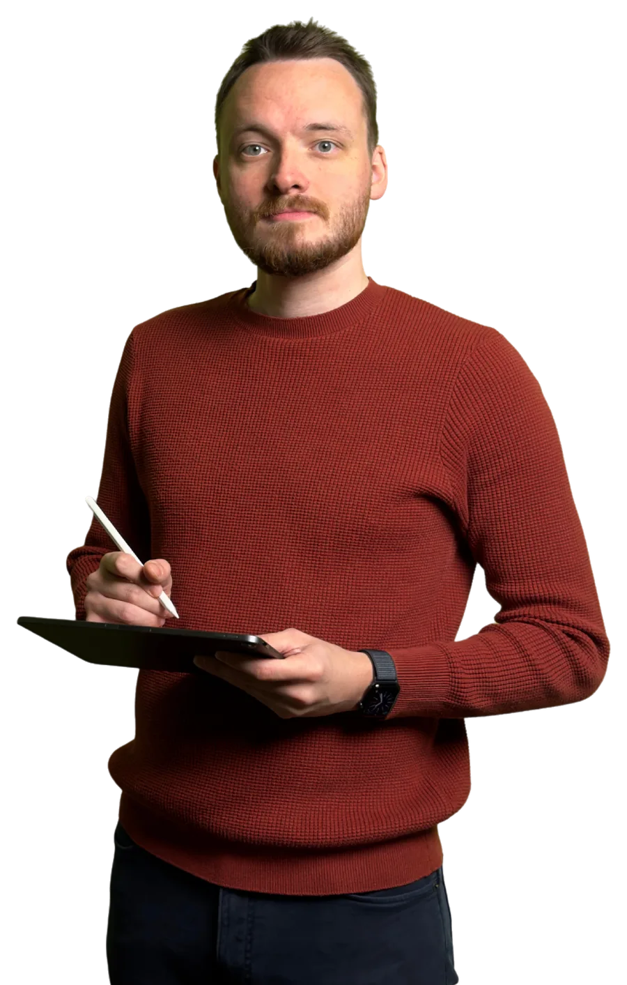 Anthony in a red jumper, writing lesson notes on a tablet
