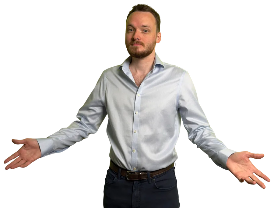 Anthony in a pale blue shirt, shrugging with his arms spread wide