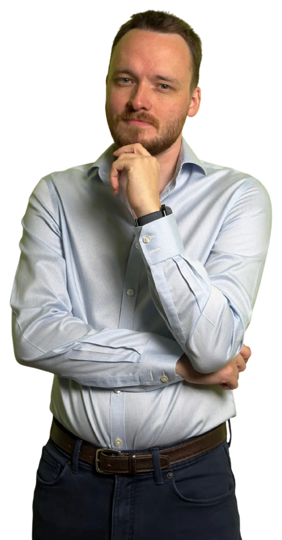 Anthony in a pale blue shirt, hand on his chin, thinking